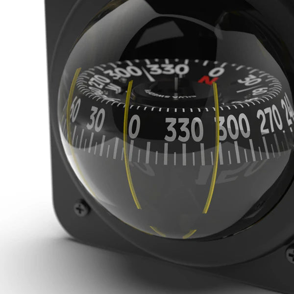 Close-up of a compass with a clear lens on a white background