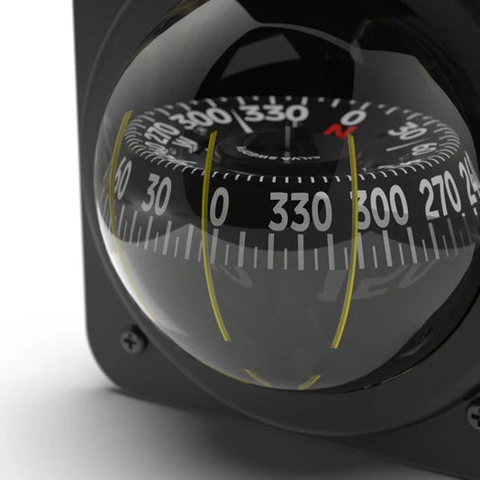 Close-up of a compass with a clear lens on a white background